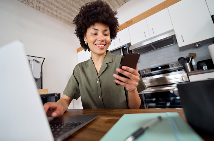 Student using laptop in kitchen